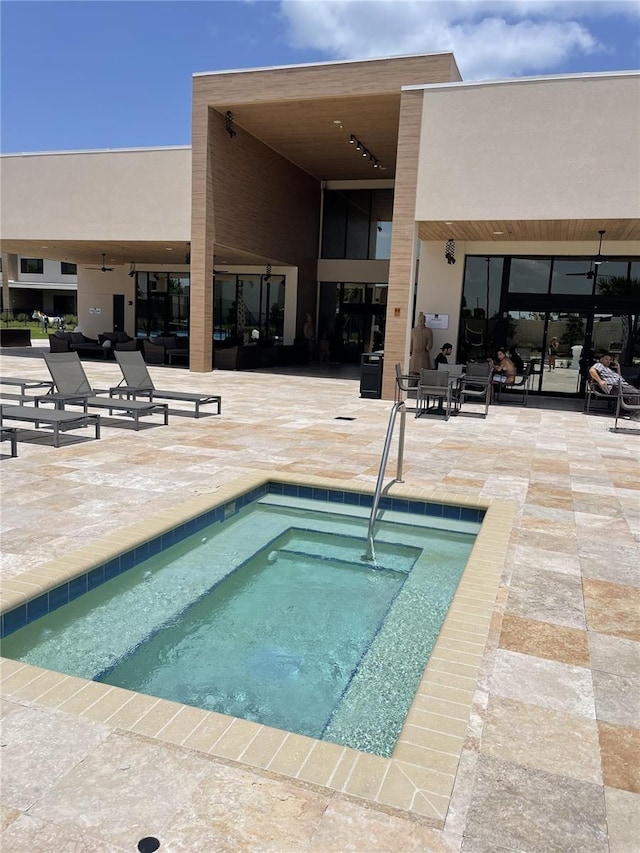 view of swimming pool with a community hot tub and a patio