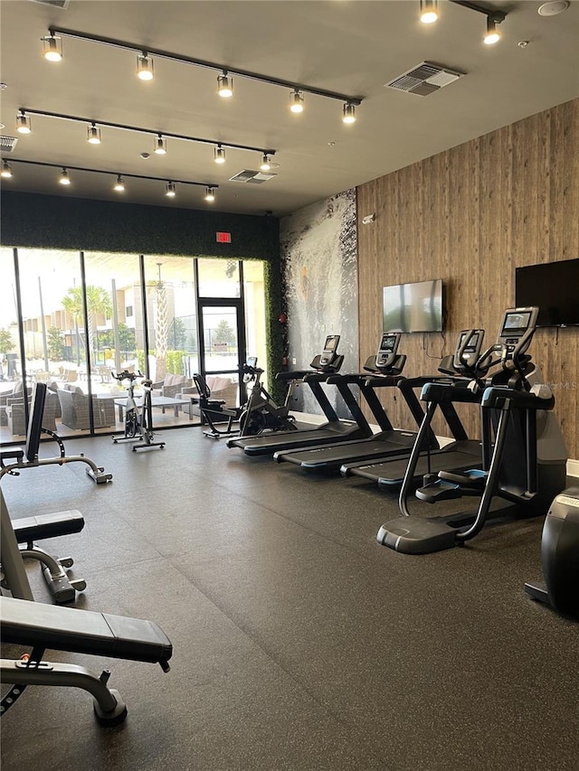 exercise room featuring wooden walls