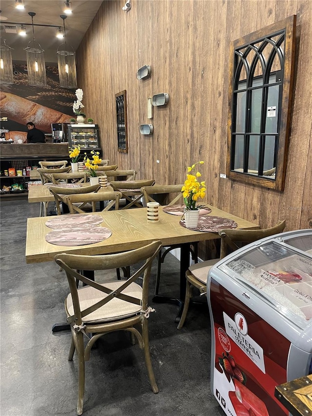 dining area featuring wood walls