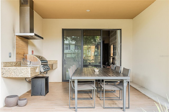 view of patio with area for grilling, outdoor dining area, and an outdoor kitchen