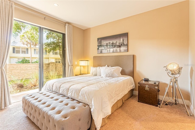 carpeted bedroom featuring access to outside and baseboards