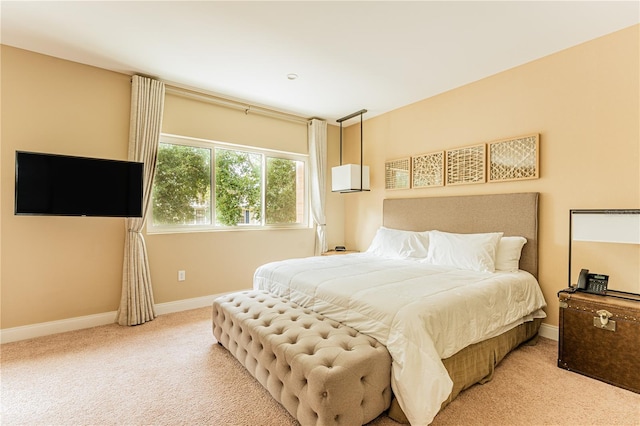 carpeted bedroom with baseboards