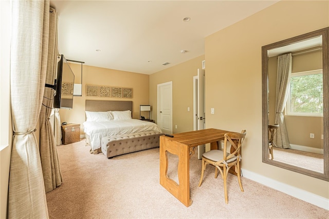 bedroom featuring light carpet and baseboards