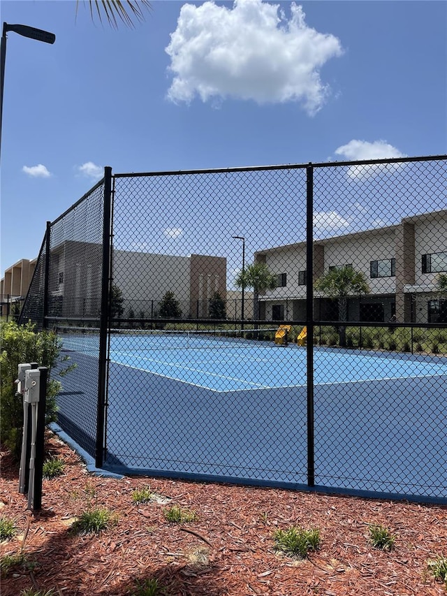 view of sport court featuring fence