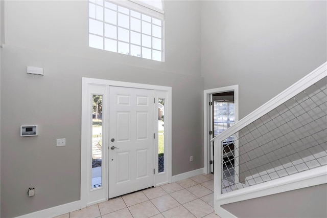 tiled entryway featuring a high ceiling