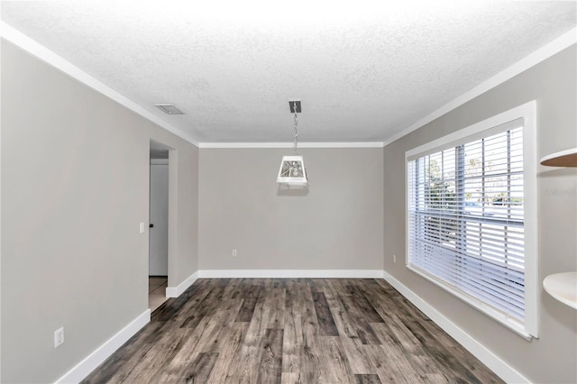 unfurnished dining area featuring a textured ceiling, dark hardwood / wood-style floors, and ornamental molding