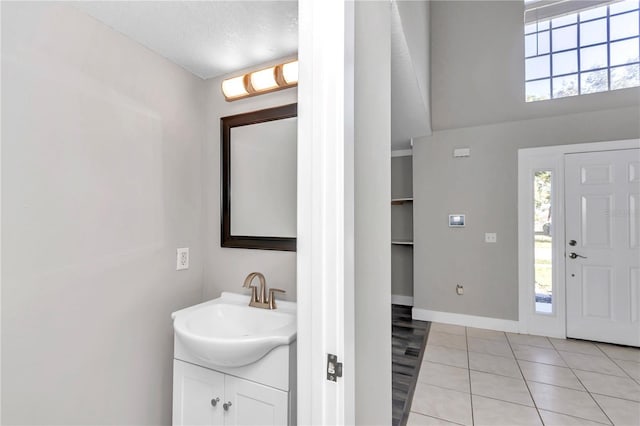 bathroom featuring a textured ceiling, vanity, and tile patterned flooring