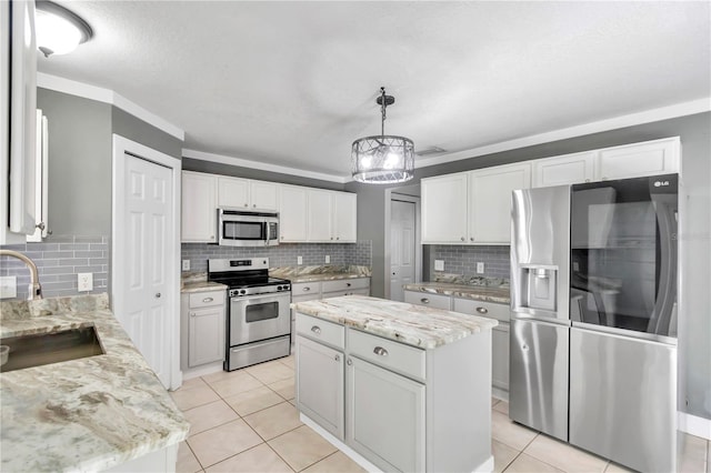 kitchen featuring sink, white cabinetry, stainless steel appliances, and a kitchen island