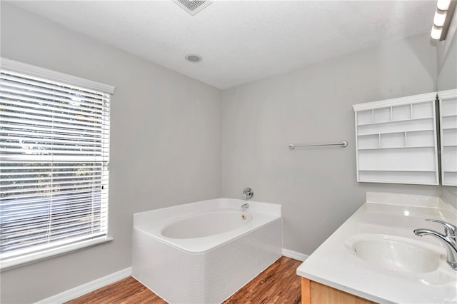 bathroom with vanity, a bathtub, and hardwood / wood-style flooring