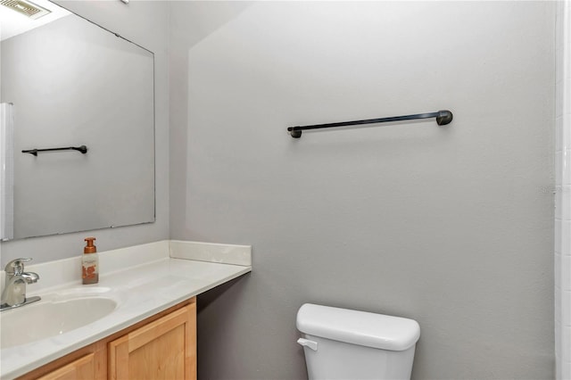 bathroom with toilet and vanity