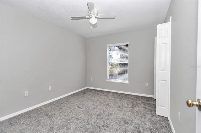 empty room featuring a textured ceiling, ceiling fan, and carpet