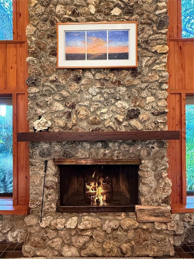 interior details with wood walls and a fireplace