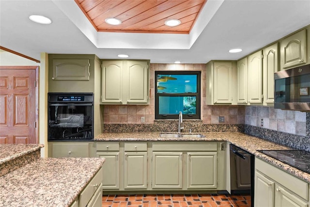 kitchen featuring tasteful backsplash, sink, black appliances, and green cabinetry