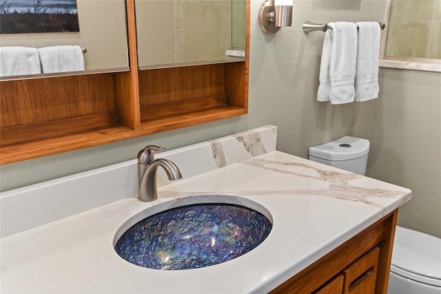 bathroom with vanity and toilet