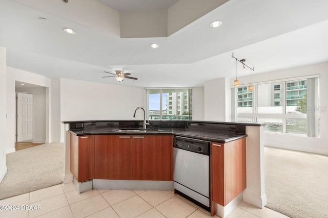 kitchen featuring pendant lighting, dishwasher, sink, and light carpet