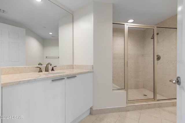 bathroom with tile patterned floors, vanity, and an enclosed shower