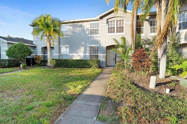 view of front of property with a front lawn and stucco siding