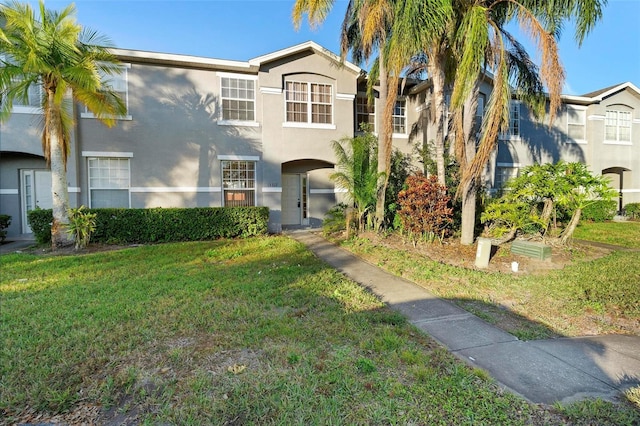 view of front facade featuring a front lawn and stucco siding