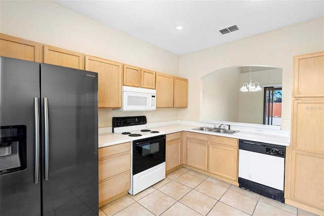 kitchen with light brown cabinetry, a chandelier, sink, and white appliances