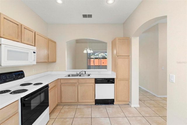 kitchen featuring white appliances, light brown cabinetry, sink, a notable chandelier, and light tile patterned flooring