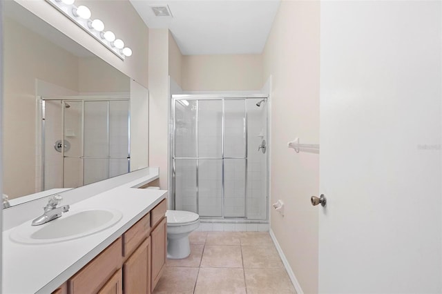 bathroom featuring a shower with door, tile patterned floors, vanity, and toilet