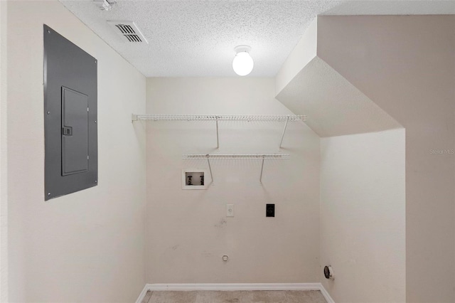 clothes washing area featuring hookup for a gas dryer, electric panel, washer hookup, a textured ceiling, and electric dryer hookup