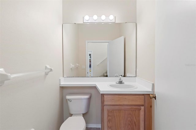 bathroom with toilet and vanity