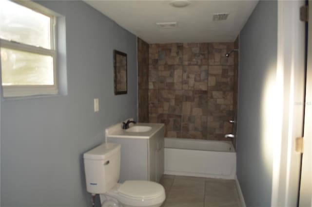 full bathroom with toilet, tiled shower / bath combo, tile patterned floors, and vanity