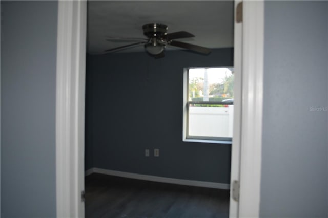 unfurnished room with ceiling fan and dark hardwood / wood-style flooring