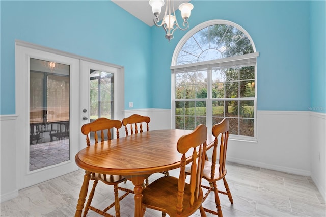 dining area with a notable chandelier and french doors