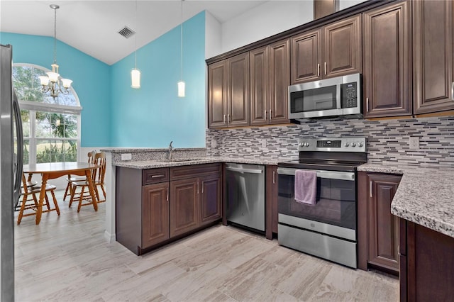 kitchen featuring dark brown cabinetry, hanging light fixtures, sink, and appliances with stainless steel finishes