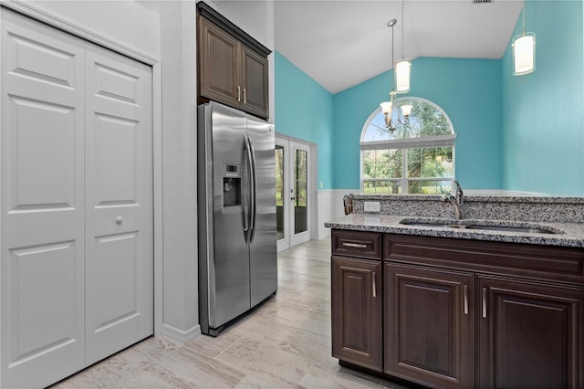 kitchen featuring sink, hanging light fixtures, an inviting chandelier, stainless steel refrigerator with ice dispenser, and dark brown cabinets