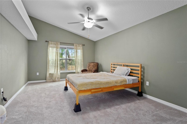 carpeted bedroom featuring ceiling fan and vaulted ceiling