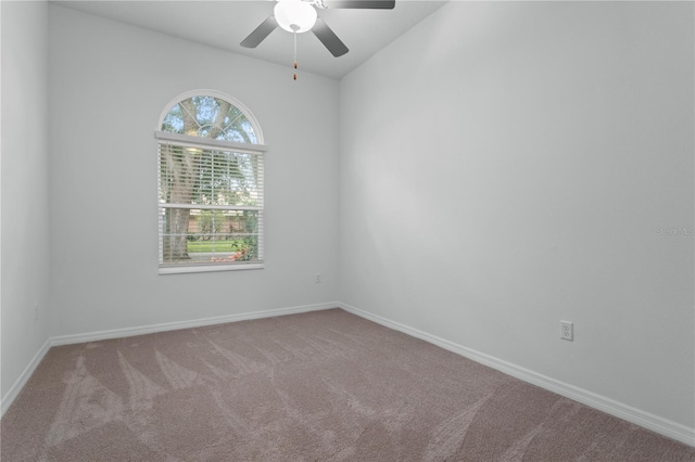 carpeted spare room featuring ceiling fan