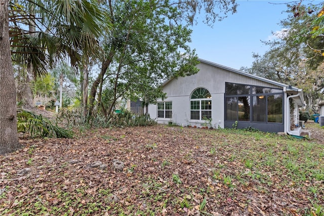 view of property exterior with a sunroom