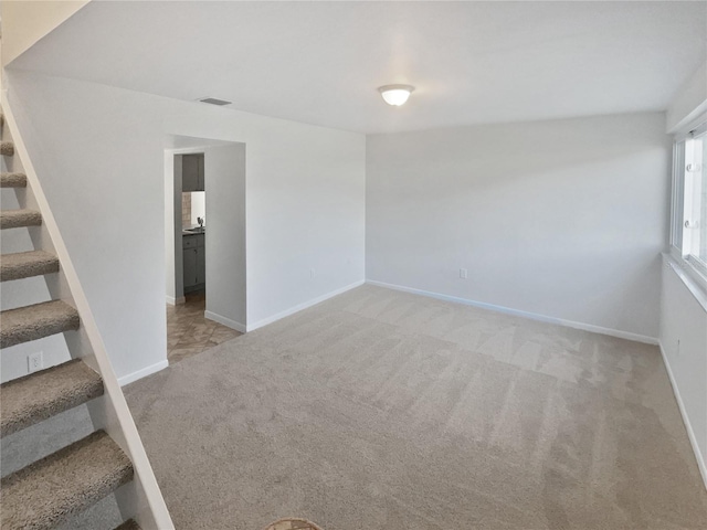 unfurnished room with light colored carpet