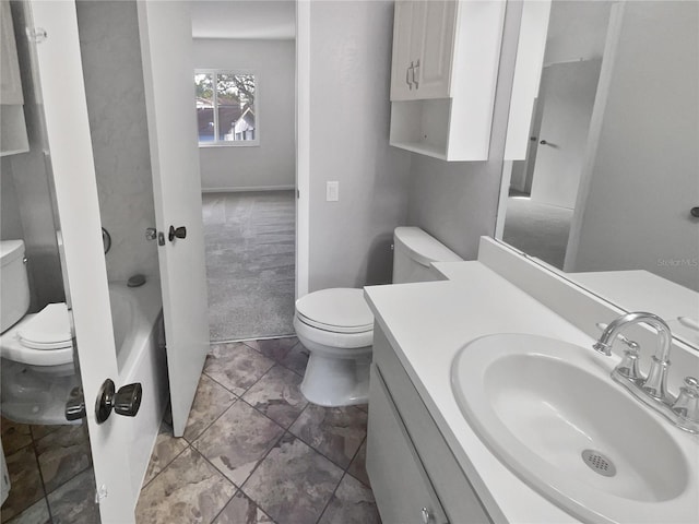 bathroom with a tub, vanity, and toilet