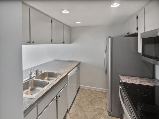 kitchen featuring dishwasher, light tile patterned floors, and sink