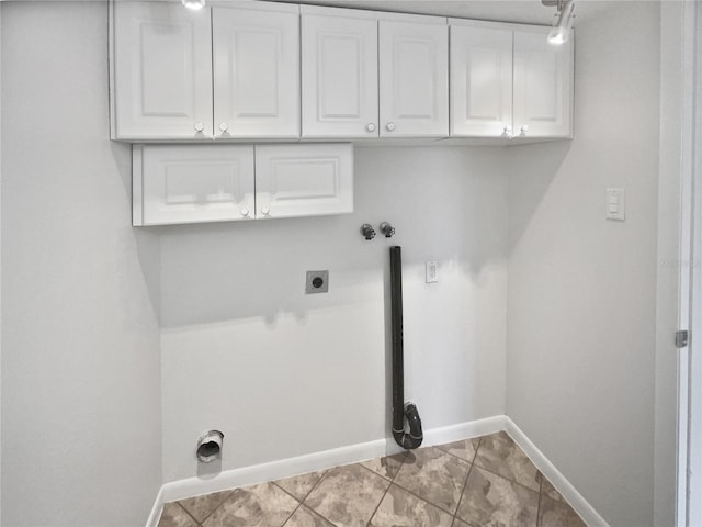 laundry room featuring electric dryer hookup, light tile patterned floors, cabinets, and washer hookup