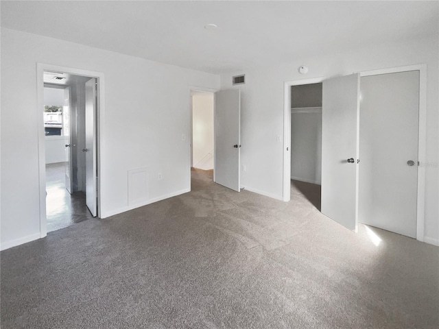 unfurnished bedroom featuring dark carpet