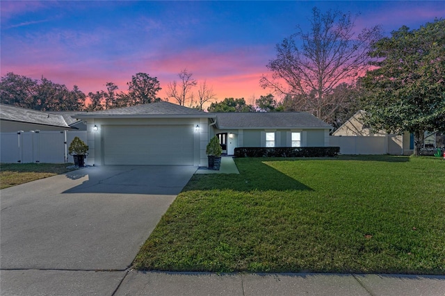 ranch-style house with a lawn and a garage