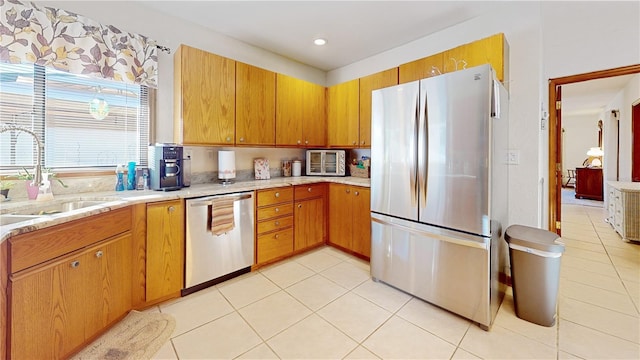 kitchen with sink, stainless steel appliances, and light tile patterned flooring