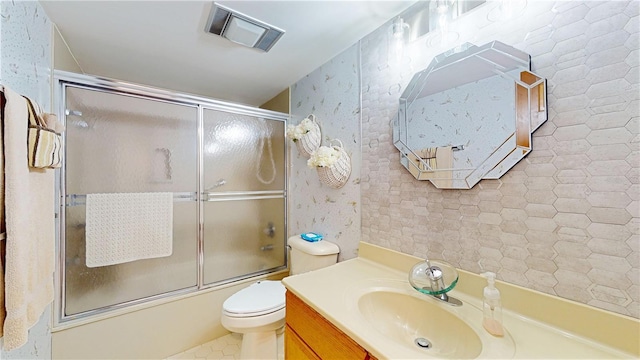 full bathroom with shower / bath combination with glass door, vanity, and toilet