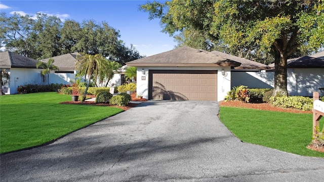 ranch-style house with a garage and a front yard