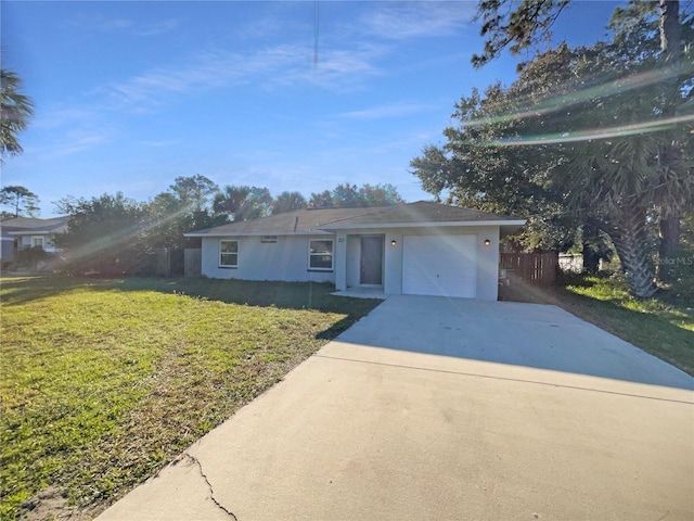 view of front of property featuring a garage and a front lawn