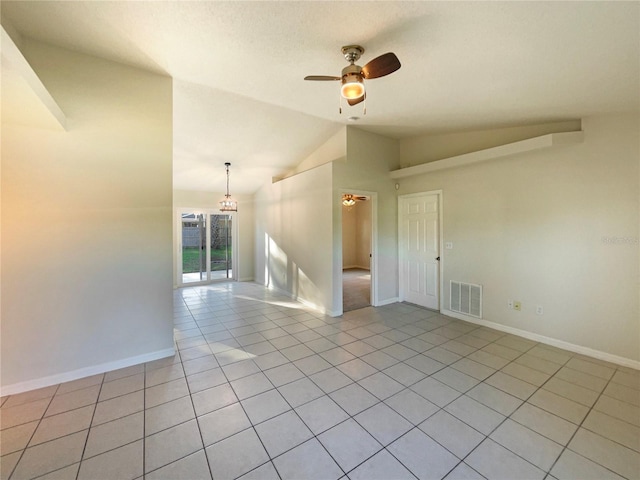 tiled empty room featuring ceiling fan with notable chandelier and vaulted ceiling