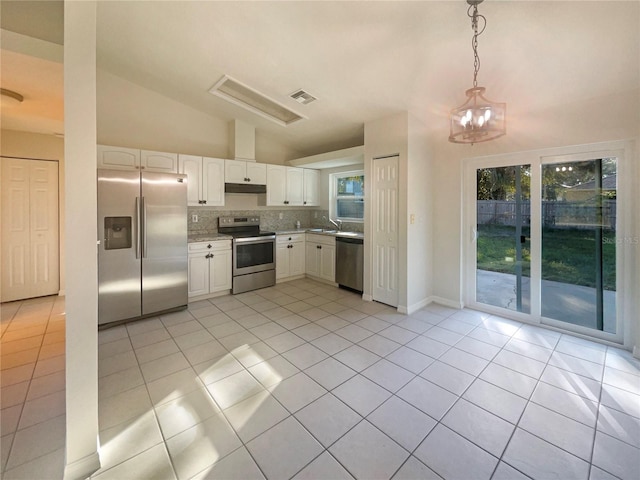 kitchen featuring tasteful backsplash, stainless steel appliances, light tile patterned floors, white cabinetry, and hanging light fixtures