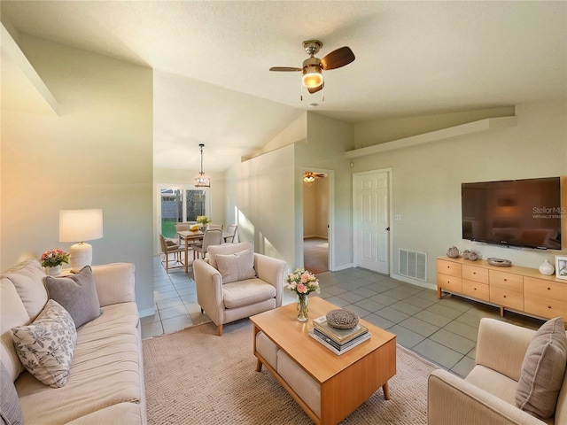 living room with tile patterned flooring, ceiling fan, and lofted ceiling