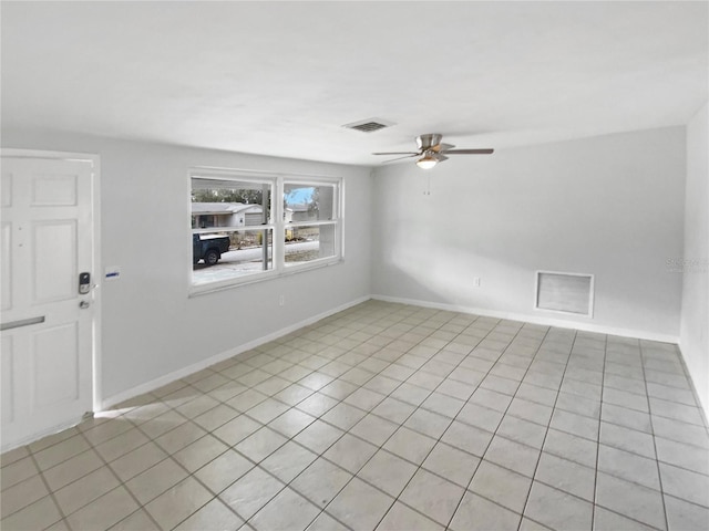 empty room featuring light tile patterned floors and ceiling fan