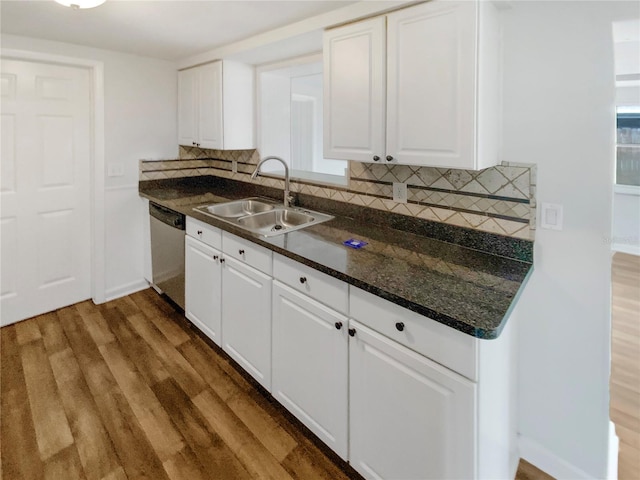 kitchen featuring sink, dark wood-type flooring, tasteful backsplash, stainless steel dishwasher, and white cabinets